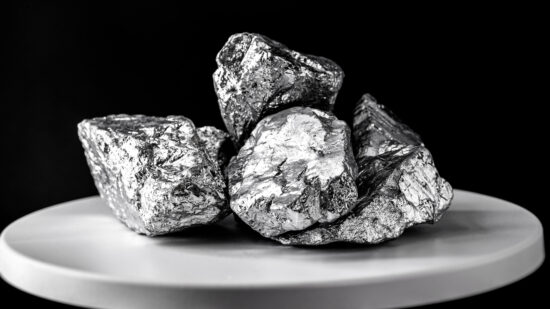 platinum stone, on electronic scale. Metal used in industry. Mineral extraction concept.