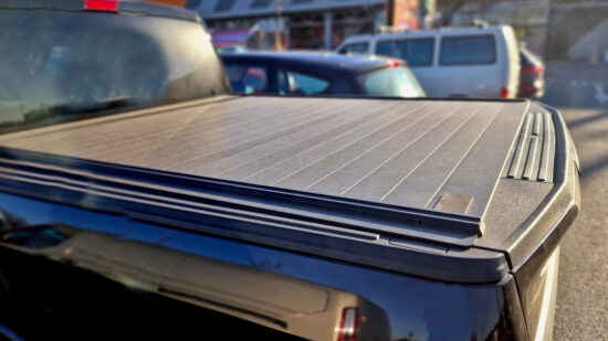 Cover with tail gate locking system designed to fit all standard vehicle security accessory offering a quick and easy way to safely lock away your load.