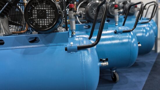 Many compressors lined up in garage